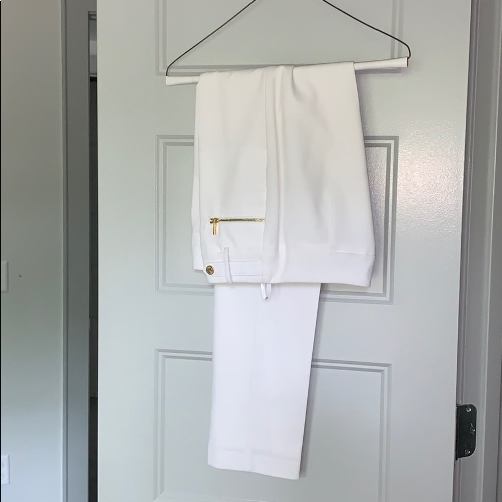 Sharp white trousers with gold buttons and zippers